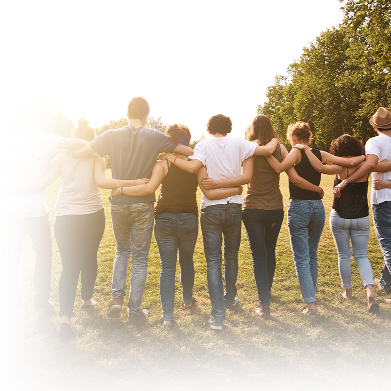 Smiling group of people walking together outdoors.